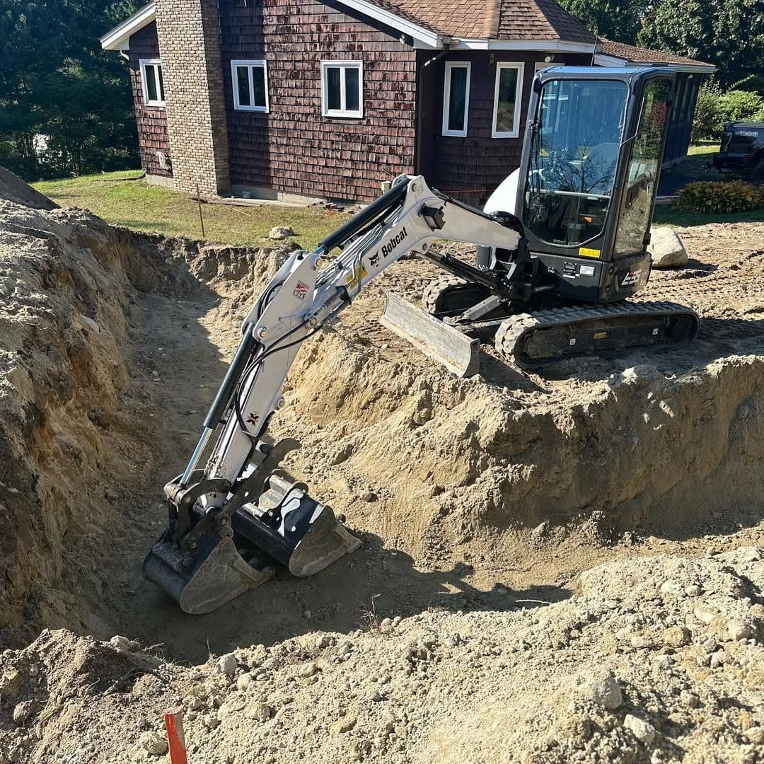 An MVP excavator digging a foundation on a job site